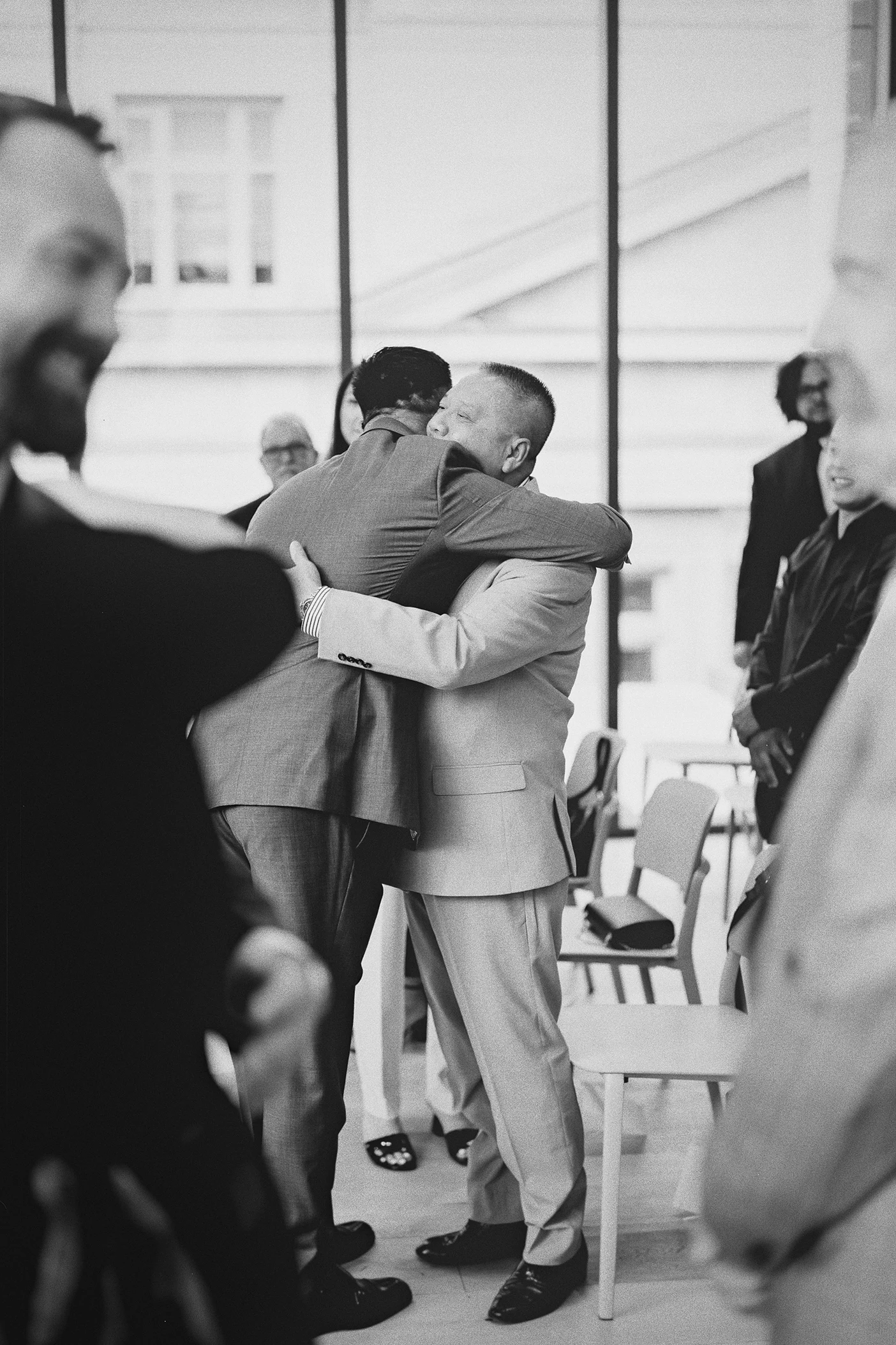 Ky hugs his father as guests and family look on.