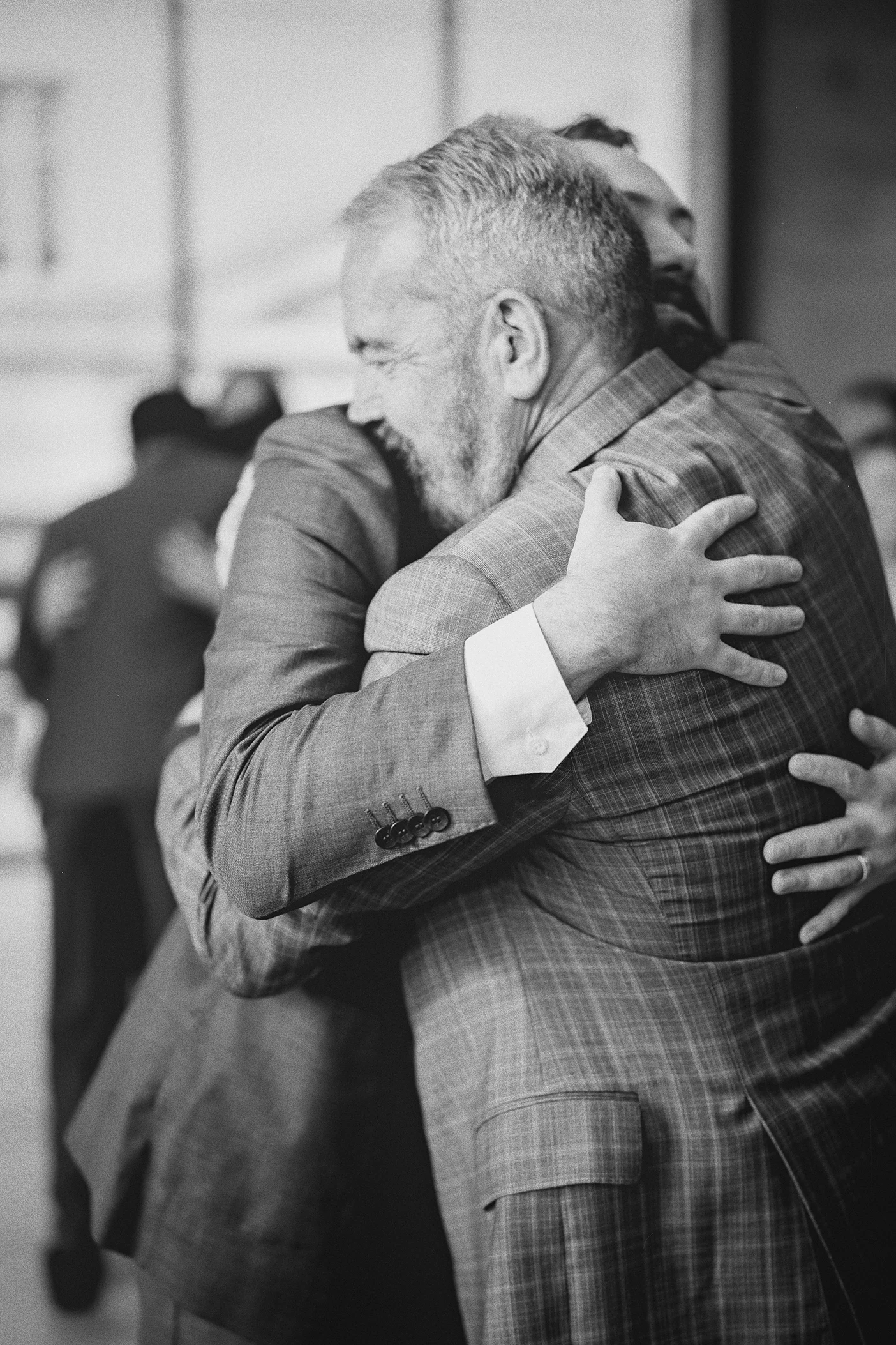 Connor and his father share a hug at the front of the aisle.