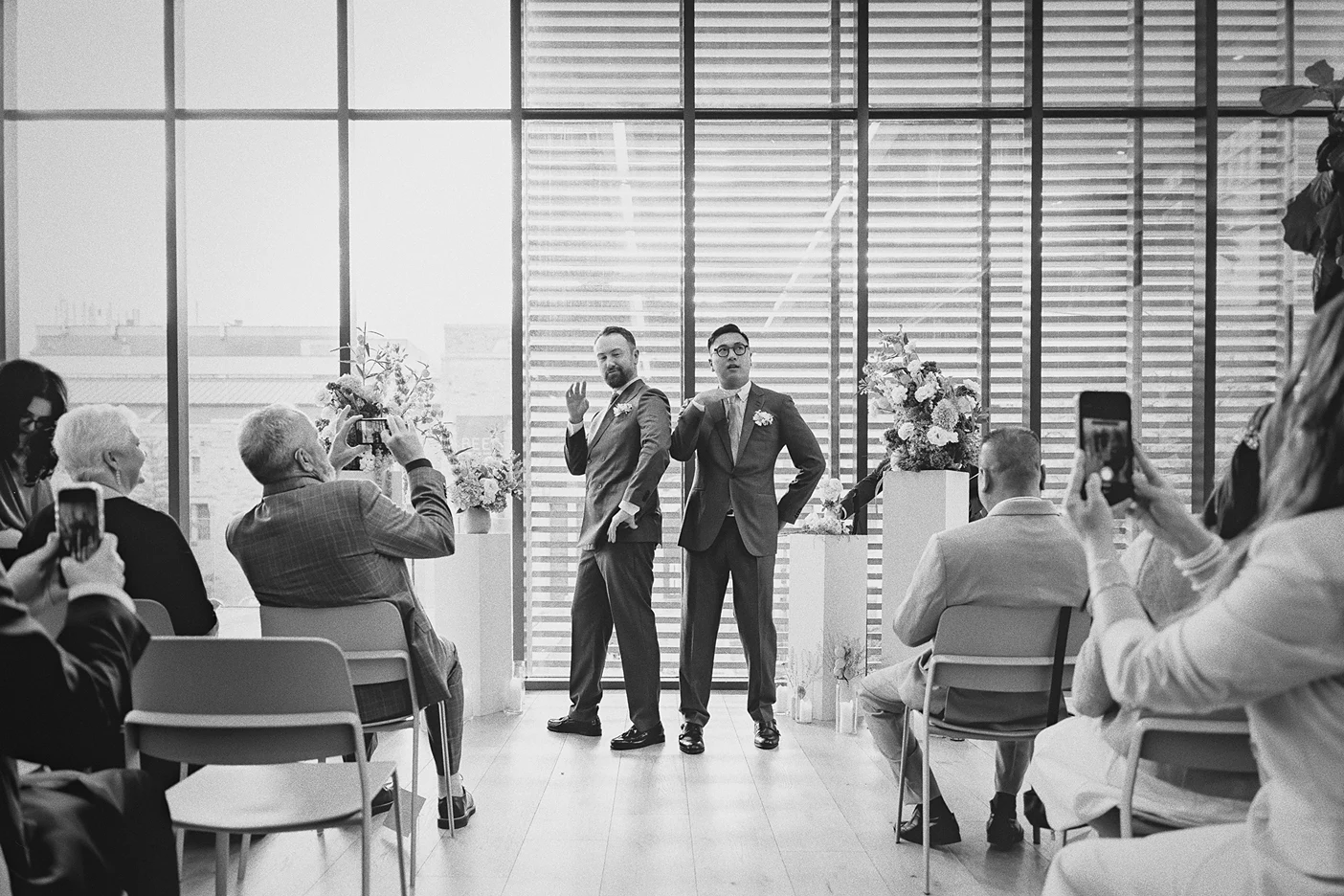 Guests capture photos of the couple during a funny moment in the ceremony.