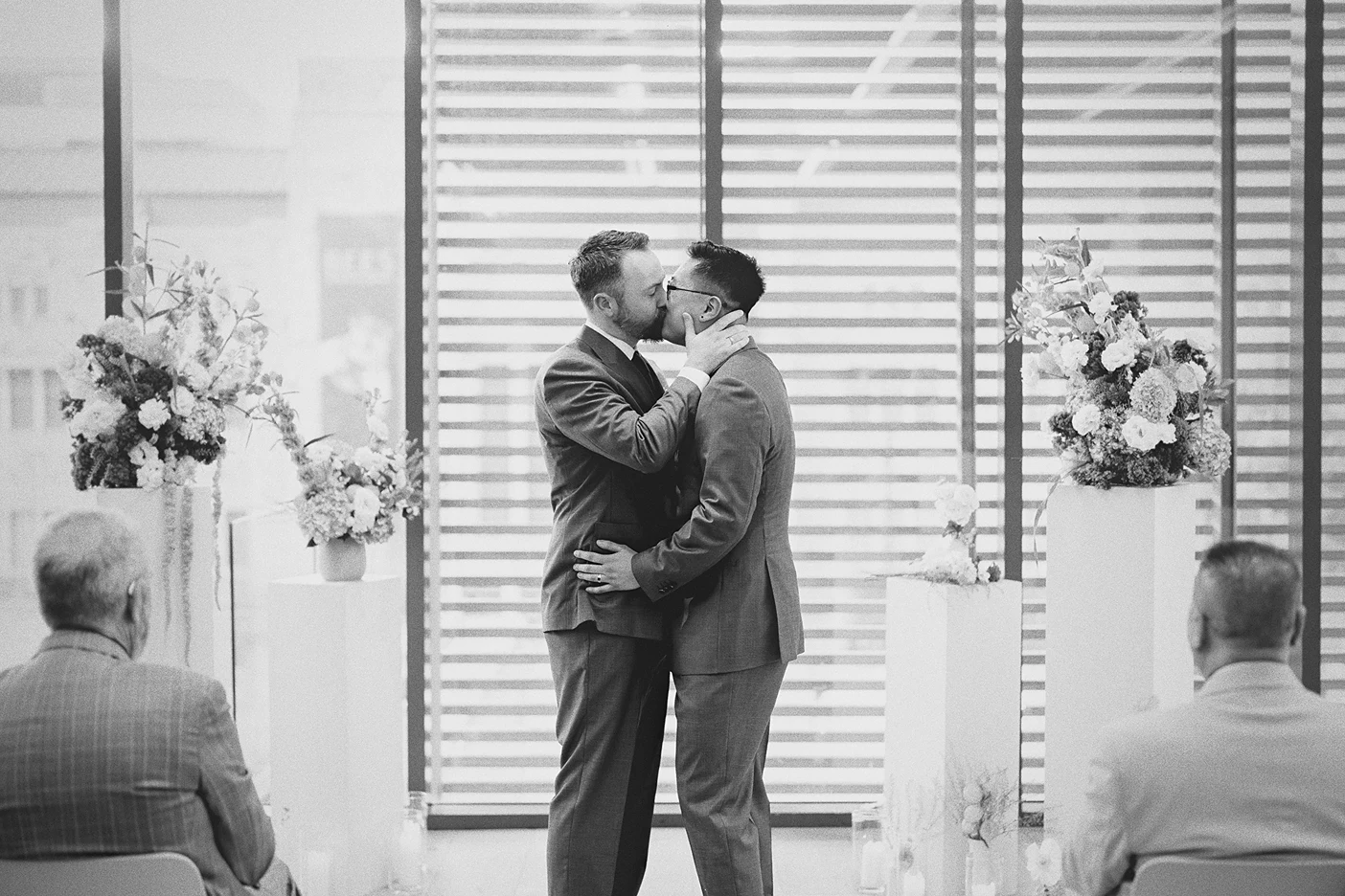 The couple shares a passionate first kiss as husbands.