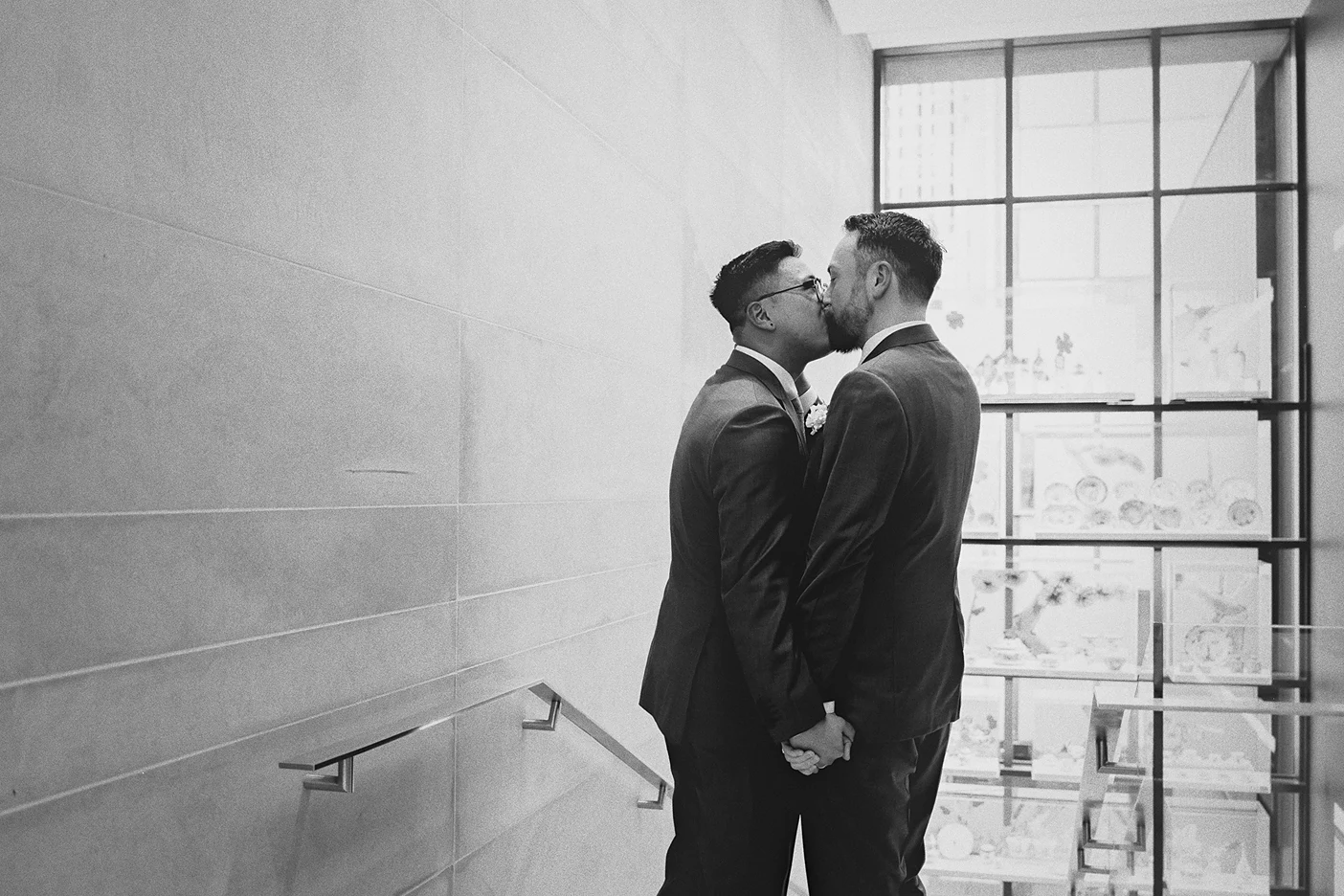 The couple shares a kiss on the staircase at the Gardiner Museum.
