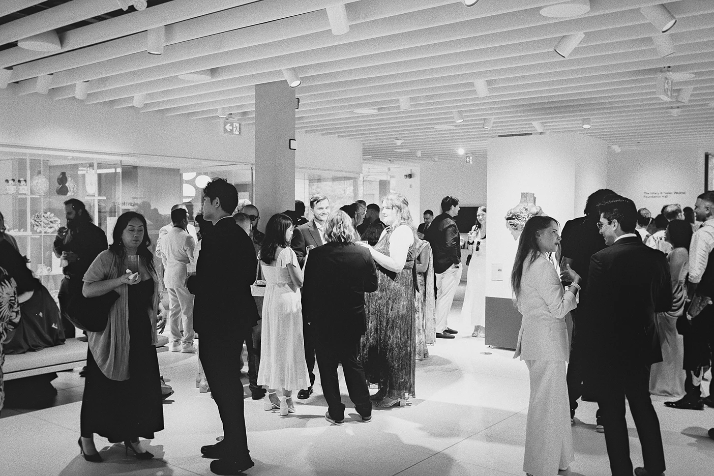 The reception is in full swing with guests enjoying the museum space.