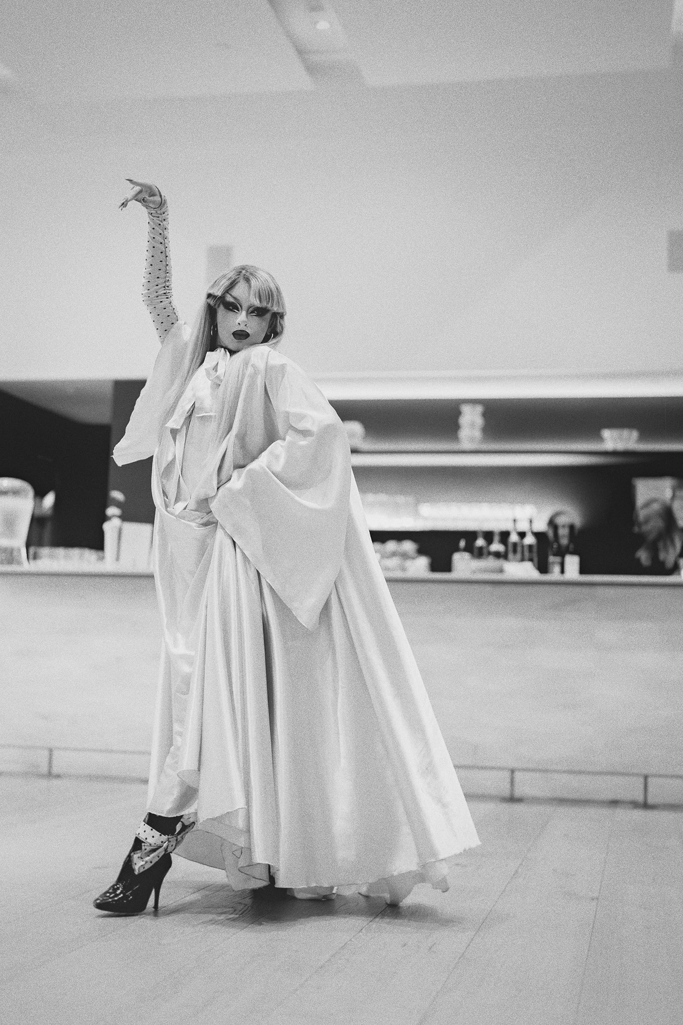 The drag performer poses dramatically during her reception performance.