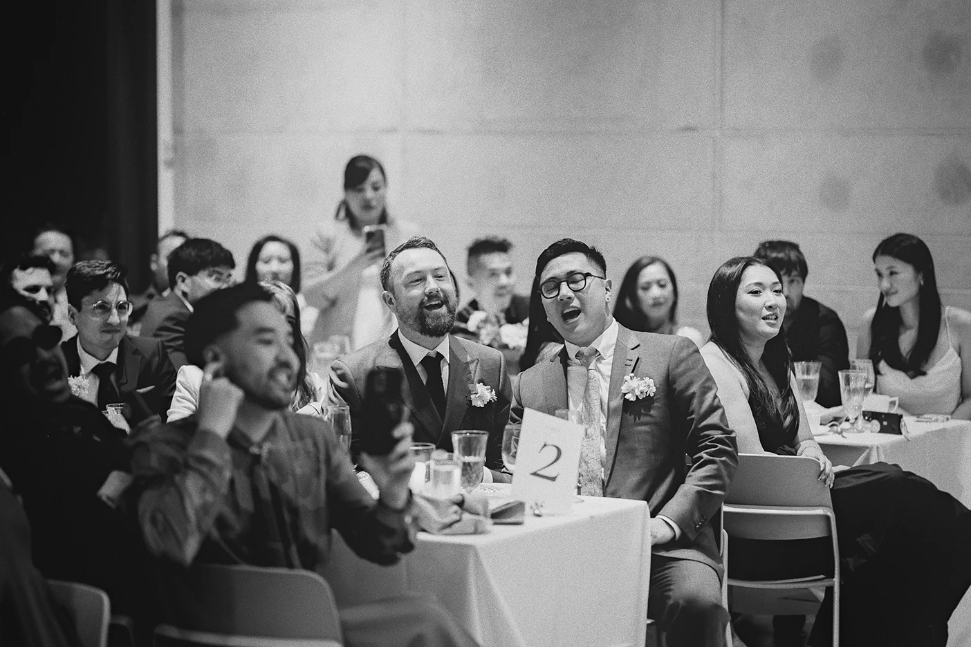 The grooms and their guests enjoy the drag show.