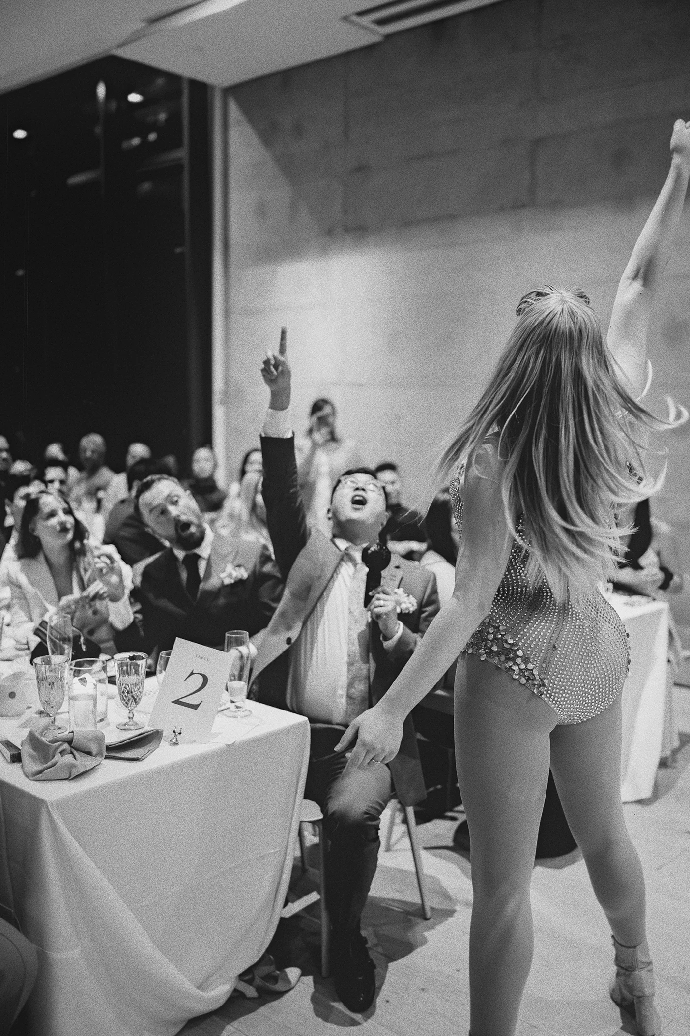 The grooms cheer enthusiastically for the drag performance.