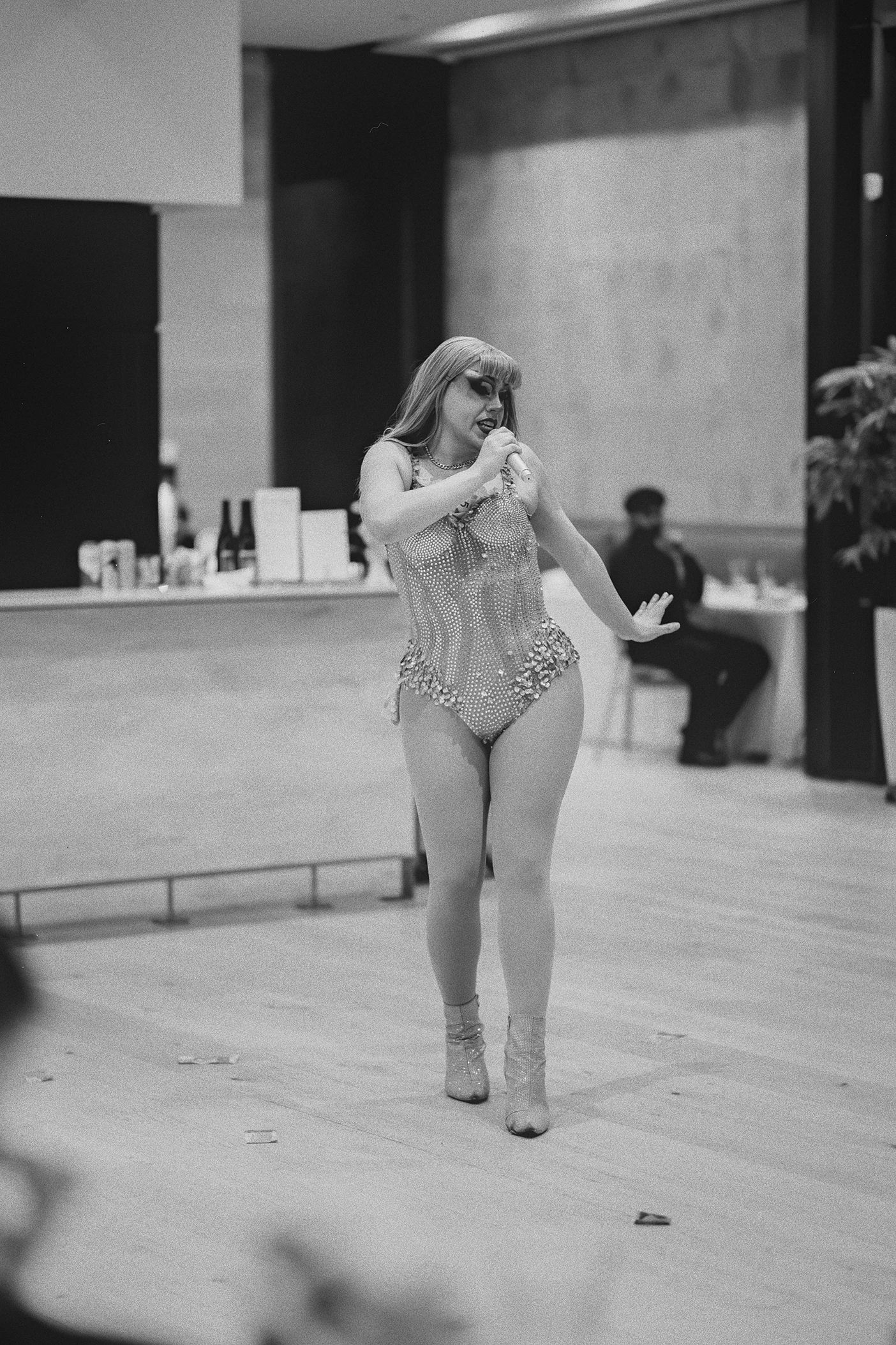 A drag queen dances for the guests at the reception.
