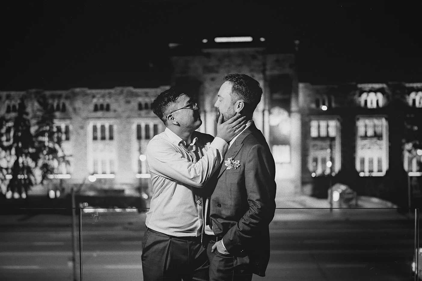 Ky holds Connor's face as they share a moment outside at night.