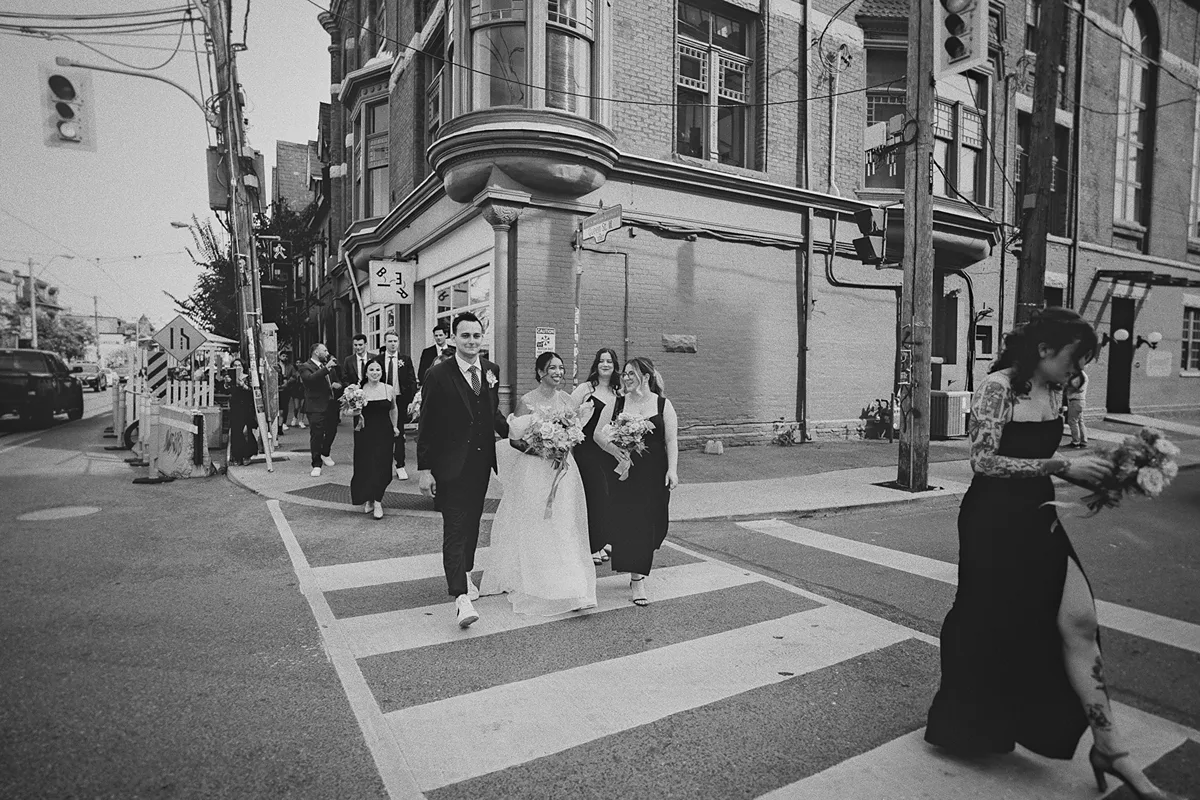 The wedding party crosses the street to The Great Hall.