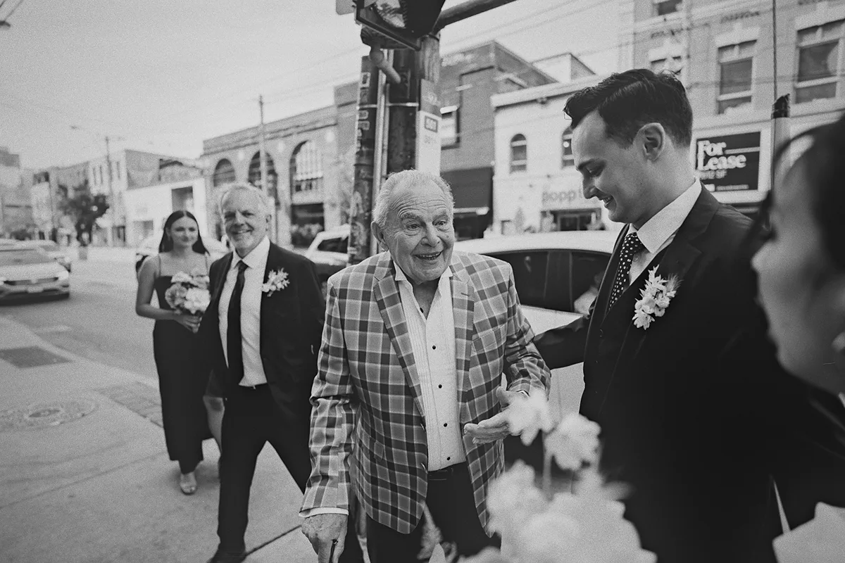 The couple greets a family member outside the venue.