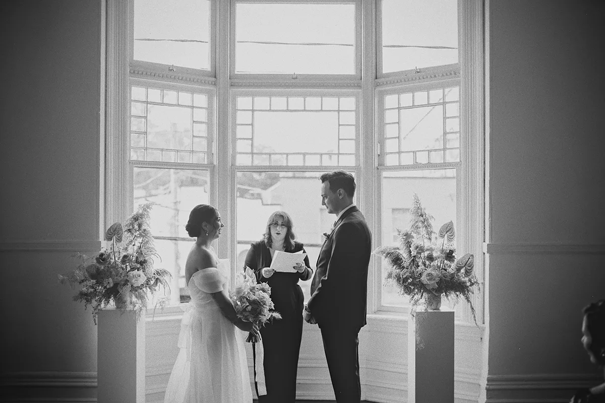The couple listens to the officiant during the ceremony.