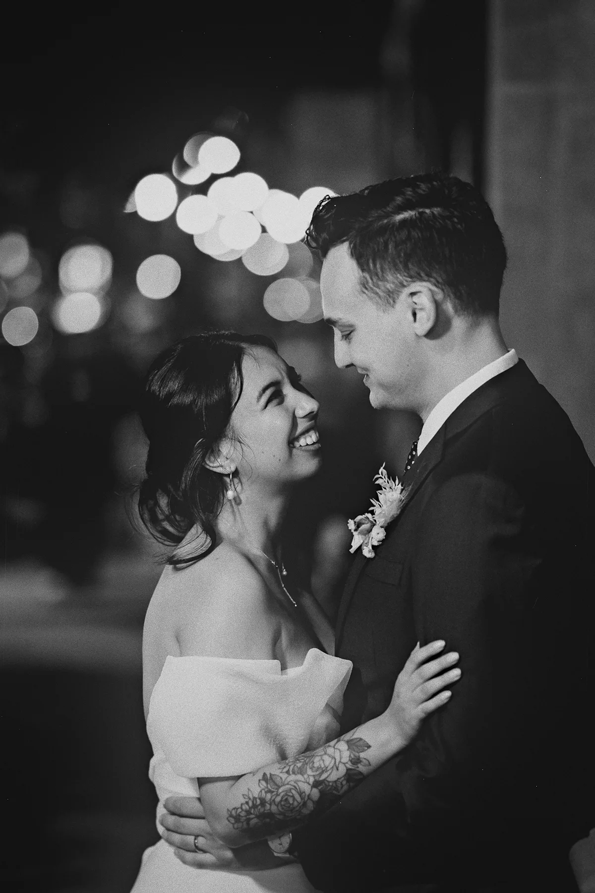 The couple smiles during their night portraits.