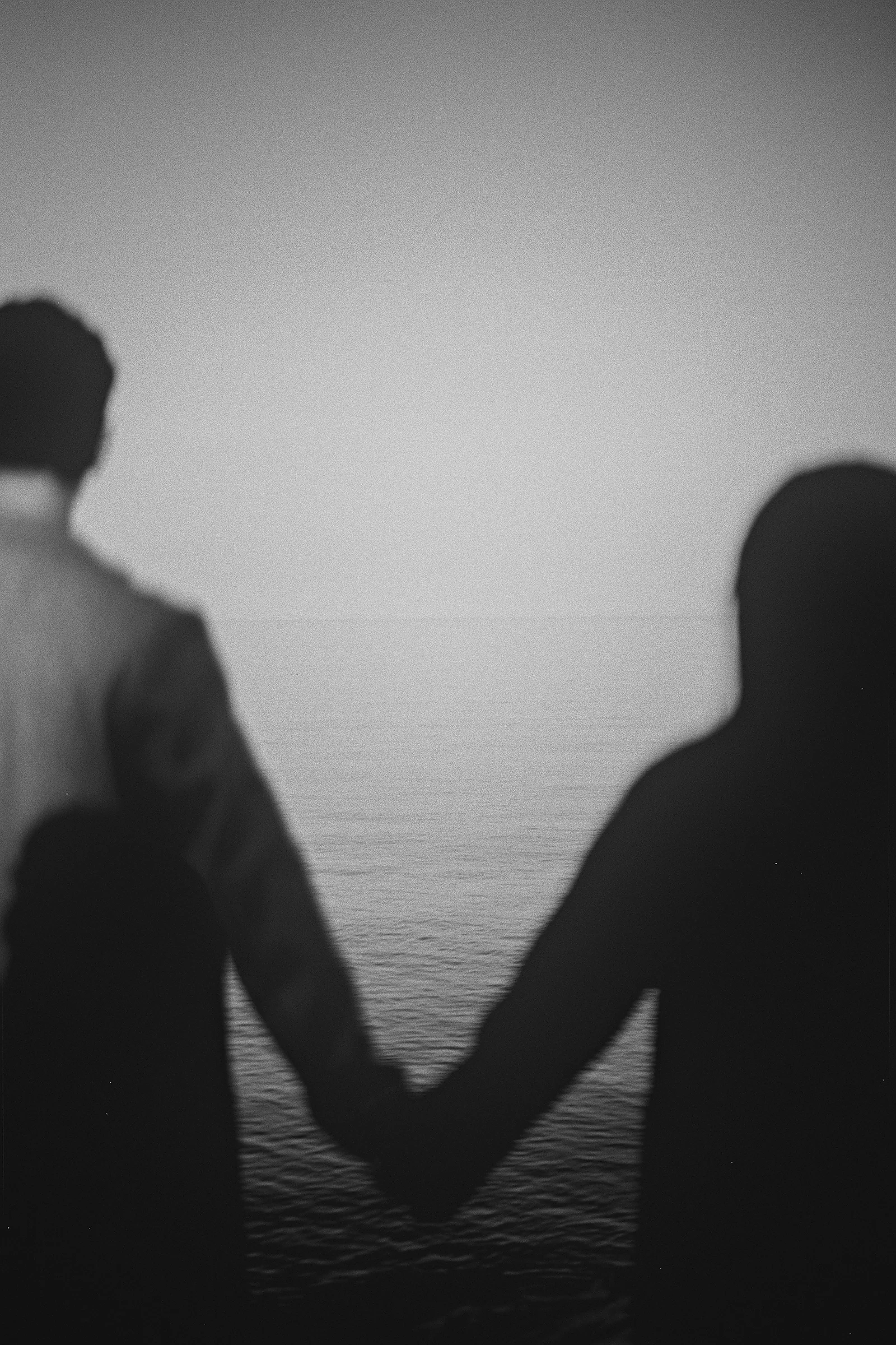 A creative silhouette of the couple holding hands