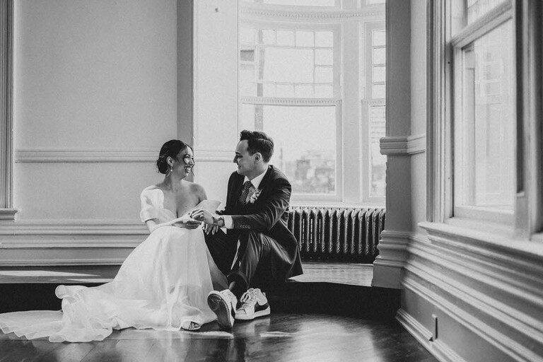 A bride and groom sit together in the Drawing Room of the Great Hall